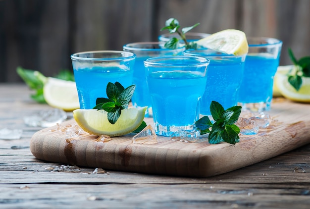 Licor de curacao azul con limón en la mesa de madera