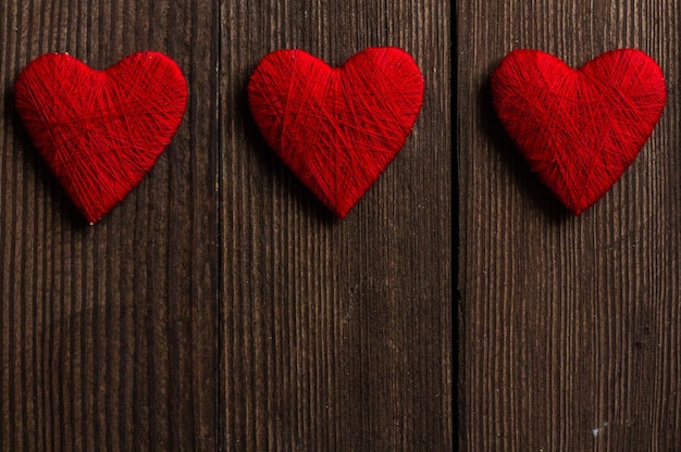 Liebesherzen auf hölzernem Texturhintergrund Valentinstagskartenkonzept