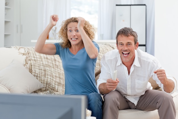 Liebhaber, die zu Hause im Wohnzimmer fernsehen