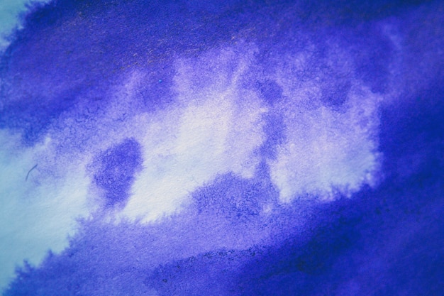 Lila Tintenfleck auf einem Blatt weißes Papiermakro. Abstrakter Hintergrund. Verteilt Tintenflecken mit Streifen auf weißem Hintergrund