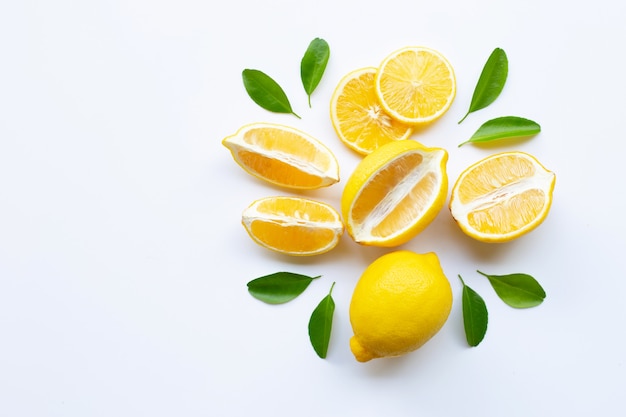 Limón y rodajas con hojas aisladas en blanco.