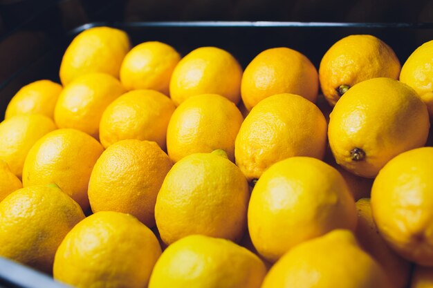 Limones frescos en una caja de madera. En la pizarra negra.