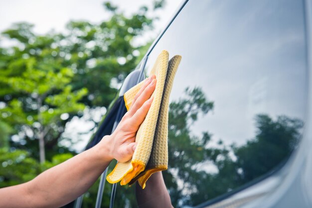 Foto limpieza del vidrio del coche con un paño de microfibras