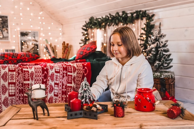 Linda chica decora un árbol de Navidad Feliz Navidad y Año Nuevo Vacaciones