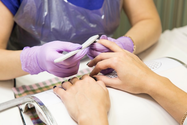 Linda chica maestra haciendo una manicura.