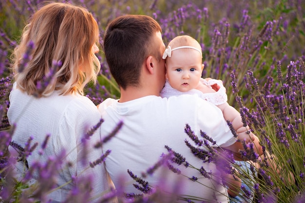 Linda família jovem no campo de lavanda flor roxa. Férias em família