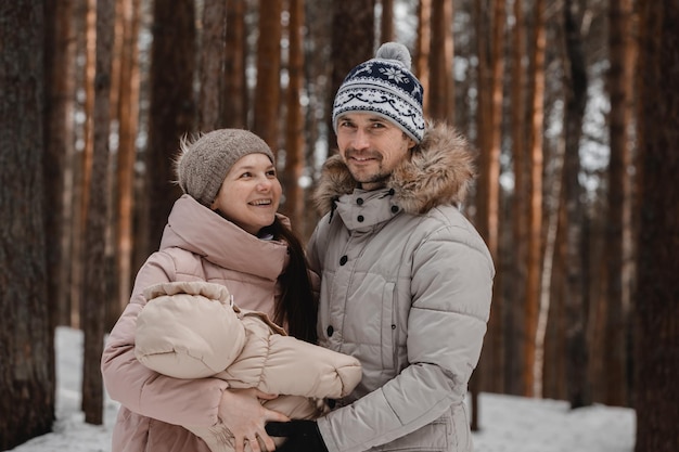 Linda família mãe pai filha No contexto de uma floresta de neve