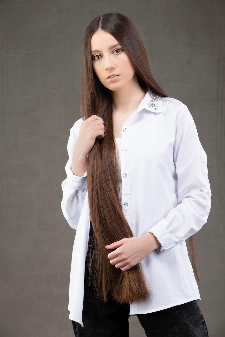 Foto linda garota com cabelo longo e reto em uma camisa branca posando