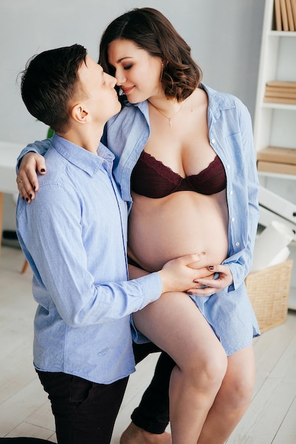 Linda garota grávida posando com o marido