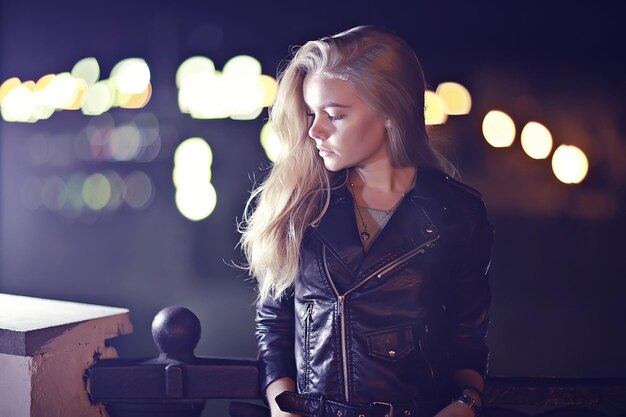 linda garota posando na cidade à noite / garota adulta modelo posando à noite na cidade, ao ar livre à noite