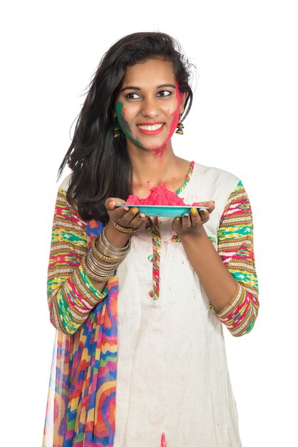 Linda garota segurando a cor em pó no prato por ocasião do festival de Holi.
