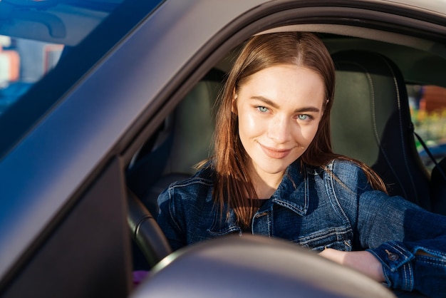 Linda jovem feliz carro Linda garota que dirige carro e sorri Retrato