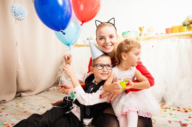 Linda madre celebrando la fiesta de cumpleaños con sus hijos