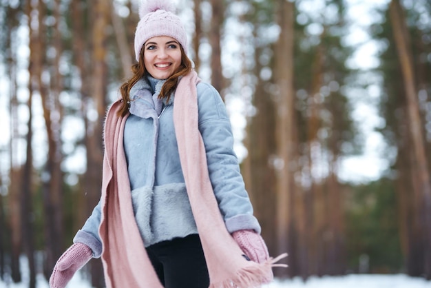 Linda mujer joven está jugando con nieve en el bosque Invierno estilo de vida felicidad emociones naturaleza