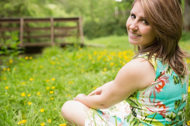 Linda mujer joven relajante en el campo