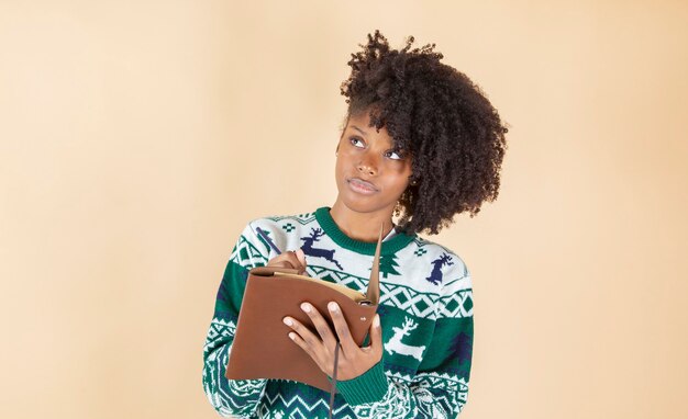 Linda mulher latina hispânica, escrevendo uma carta no Natal