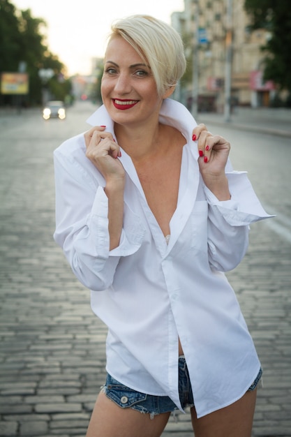 Foto linda mulher loira com uma camisa branca