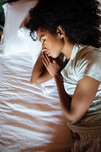 Foto linda mulher negra dormindo na cama