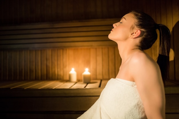 Linda mulher relaxante na sauna