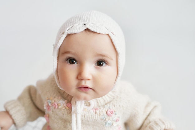 Linda niña en ropa de punto y sombrero con osito de peluche Día de protección infantil Tarjeta de felicitación del día de la madre Día internacional de la felicidad