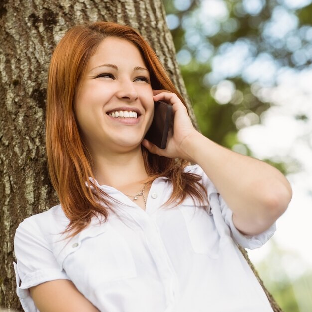 Linda ruiva sorrindo no telefone