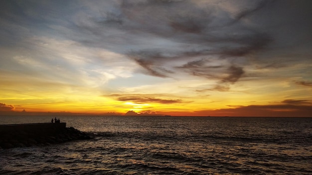 Foto lindas nuvens no céu com um cenário de nascer do sol e o mar