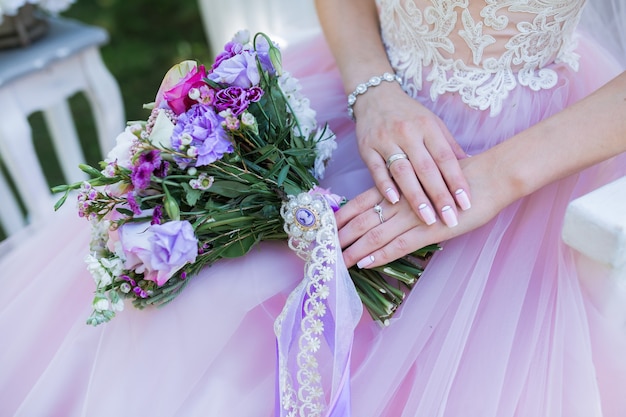 Lindo buquê colorido de casamento com flores diferentes nas mãos da noiva. Bouquet de noiva de verão