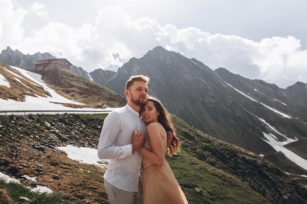 Lindo casal de noivos noivos apaixonados no fundo das montanhas