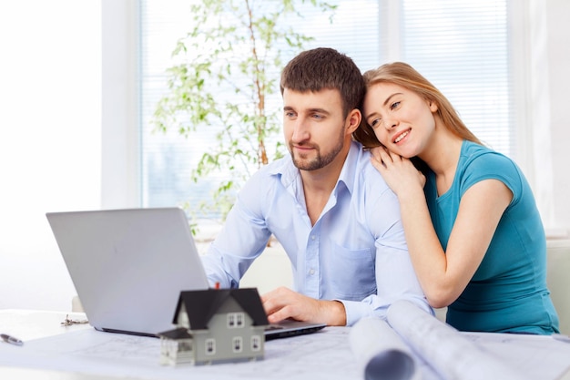 Lindo casal feliz usando laptop juntos