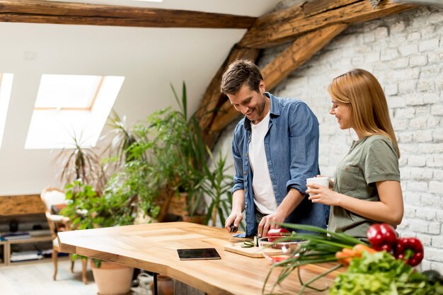 Lindo casal jovem alegre cozinhar jantar juntos