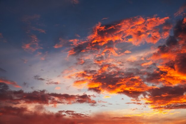 Lindo céu brilhante e colorido. Foto tirada ao pôr do sol. Fundo vermelho-laranja com belas tintas. Nascer do sol raro. Composição natural