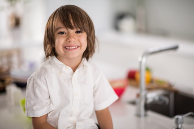 Lindo niño adorable en la cocina