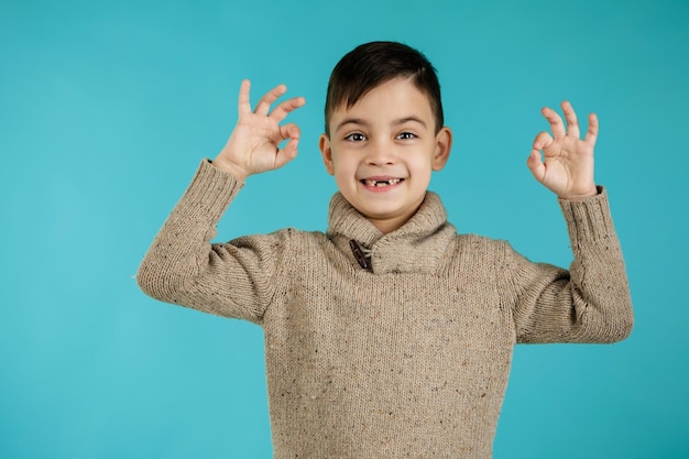 Lindo niño en camiseta haciendo gesto ok