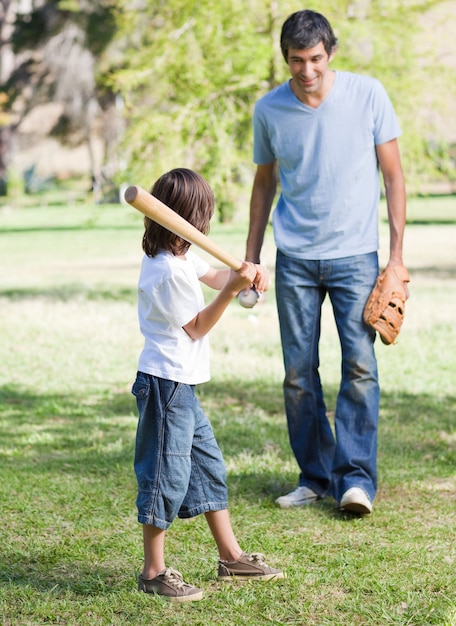 Lindo niño jugando al béisbol con su padre