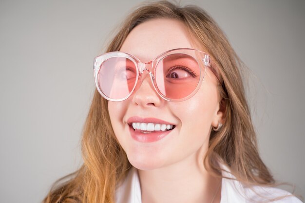 Lindo rosto de jovem sorridente com óculos de sol