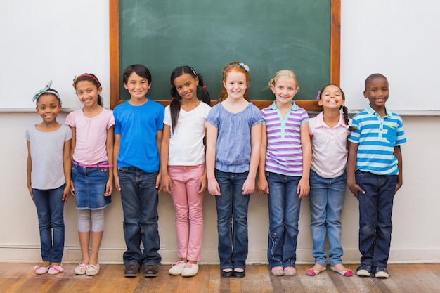 Foto lindos alumnos sonriendo a la cámara en el aula