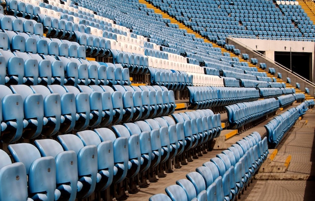 Líneas de sillas de espectadores de plástico vacías en una tribuna