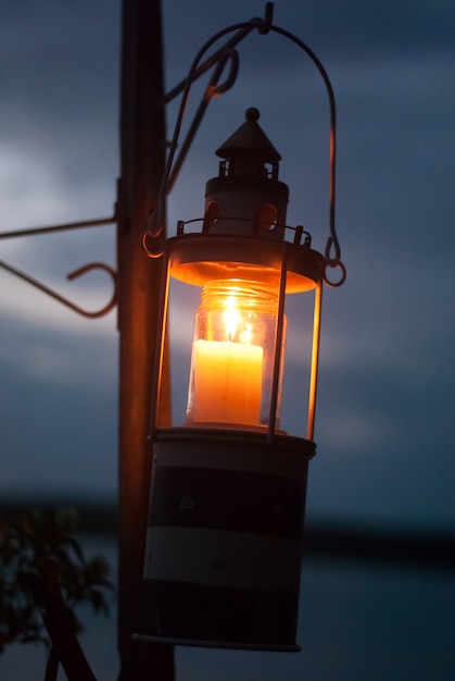 Linterna resplandeciente con vela por la noche