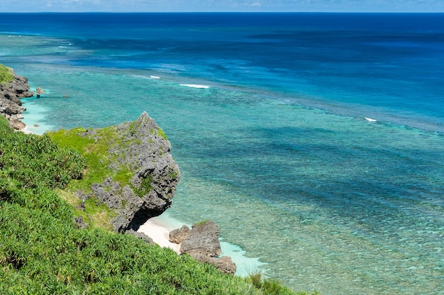 Litoral deslumbrante com vegetação verde, pequenas praias e mar de um azul profundo. Ilha Yonaguni