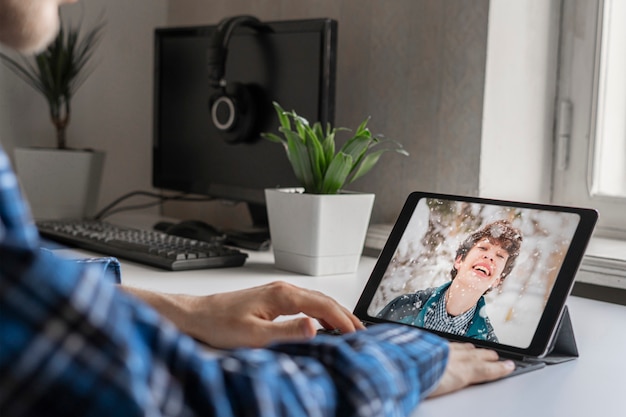 Una llamada al amigo y una conversación mediante el chat de video en el dispositivo de computadora portátil.