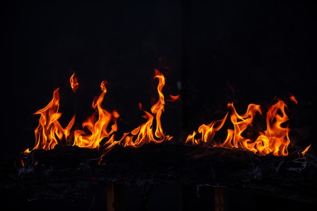 Llamas de fuego sobre fondo negro Textura abstracta aislada de llama de quemadura de fuego Explosión de llamas con efecto de quema Patrón de arte abstracto de fondo de pantalla de fuego con espacio de copia