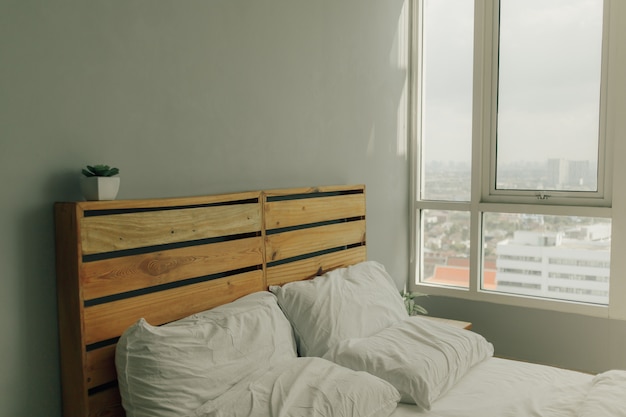 Loft cabecero de madera de pino con cama blanca.