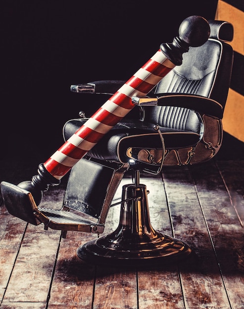 Foto logotipo del símbolo de la barbería elegante silla de peluquero vintage estilista en el interior de la barbería silla de barbería sillón de barbería salón de peluquería para hombres poste de peluquería