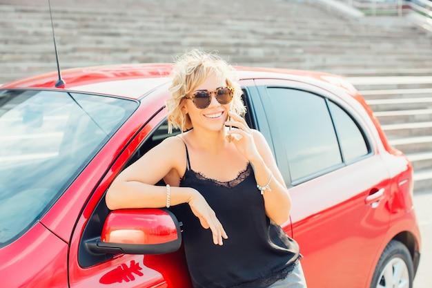 Loira atraente em um carro mostrando as chaves