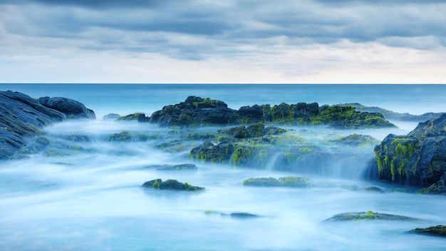 Longa exposição de oceano misterioso e rochas