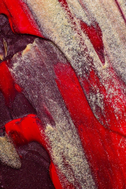 Foto longas pinceladas de tinta ouro preto vermelho