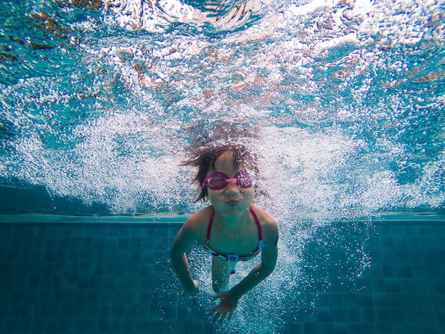 La longitud completa de la mujer en la piscina