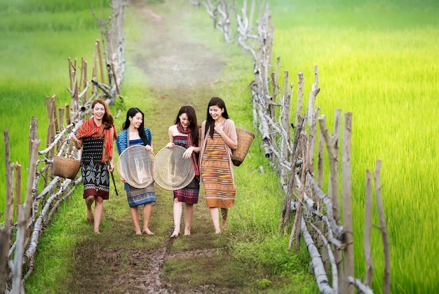 Longitud completa de mujeres sonrientes caminando por el campo agrícola