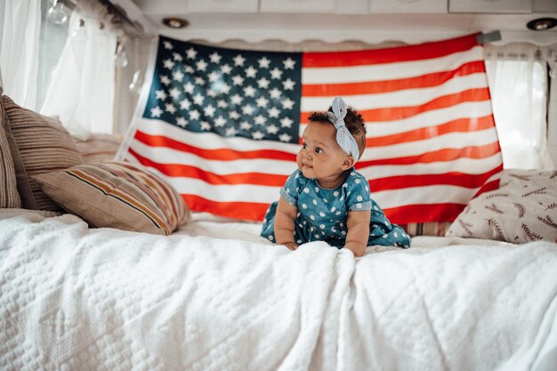 Foto la longitud completa de una niña linda en la cama