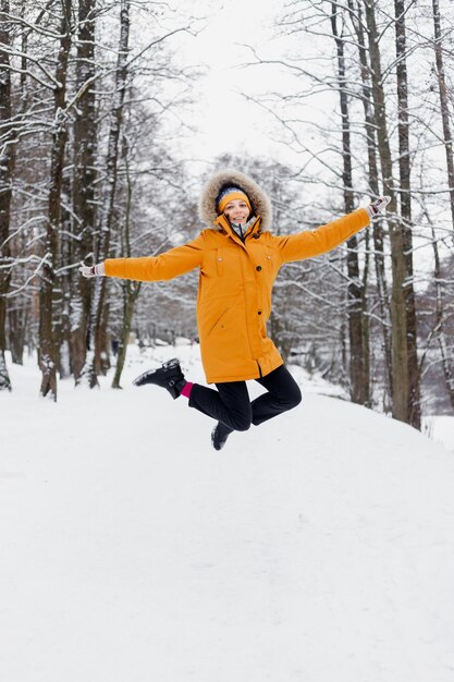 Foto longitud total de la persona en terreno cubierto de nieve